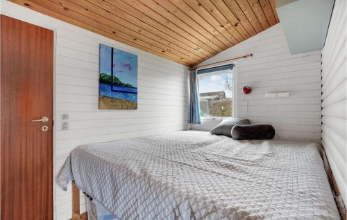 a bed in a room with a window at Cozy Home In Assens With House Sea View in Assens