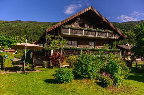 a wooden house with plants on the roof at Landhaus BERGSEE in Bodensdorf