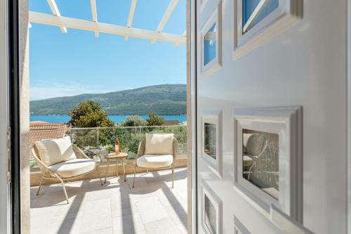 a view from the living room of a house with a balcony at Bella Vista Luxure Apartments in Baošići