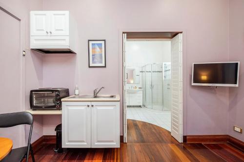 een keuken met een wastafel en een magnetron bij Dawson Accommodation in Fremantle