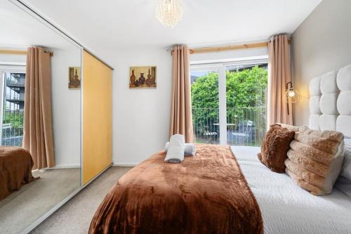 a bedroom with a large bed and a large mirror at Cityfront Luxe Apt Near City Centre Facing Etihad & Coop Live, Free Parking in Manchester
