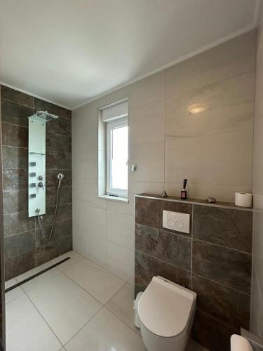 a bathroom with a toilet and a shower at Villa Anita in Sveti Filip i Jakov
