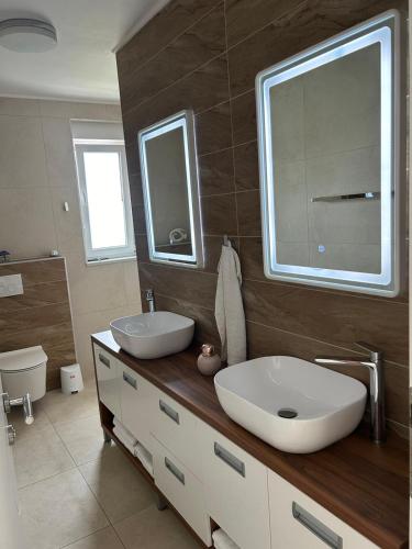 a bathroom with a white sink and a mirror at Villa Anita in Sveti Filip i Jakov