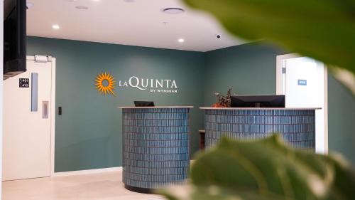 a company office with a sunitta sign on the wall at La Quinta by Wyndham Parnell Auckland in Auckland