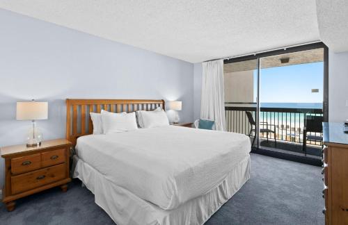 a bedroom with a large bed and a balcony at SunDestin Resort Unit 0814 in Destin