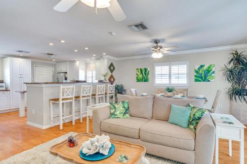 a living room with a couch and a kitchen at Fort Myers Bungalow - 12 Miles to the Beach! in Fort Myers