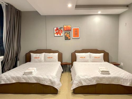 a bedroom with two beds with white comforter at Nice apartment in Vung Tau WE WELCOME YOU! in Vung Tau