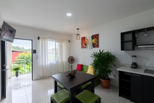 a kitchen and living room with a table and chairs at Apartamentos La Casona in Fortuna