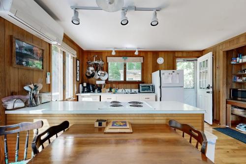 a kitchen with a large white island in a room at Ladyslipper Cottage in Somesville