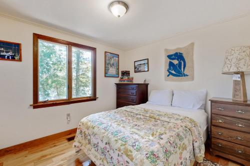 a bedroom with a bed and a window at Ladyslipper Cottage in Somesville