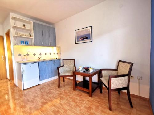 a room with a table and chairs and a kitchen at Durakovic Apartments in Herceg-Novi
