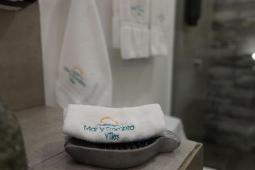 a pile of towels sitting on top of a counter at Mar y Sombra Villas in Quepos