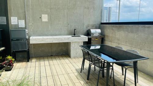 a counter with chairs and a desk on a balcony at Cozy apartment with terrace, SJ Cosmopolitan Tower #402 in San José
