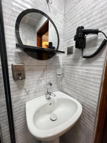 a bathroom with a sink and a mirror at Kaliptus Hotel in Kemer