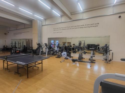 a gym with a ping pong table in a room at Harcombe House Bungalow 10 in Newton Abbot