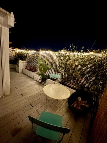 a table and chairs on a patio at night at ROOFTOP-MarinaCentro-Unique-Beach-Fun-Smart-LoveApt-Train-Park in Rimini