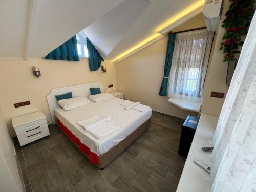 a bedroom with a large bed in a room at Kaliptus Hotel in Kemer