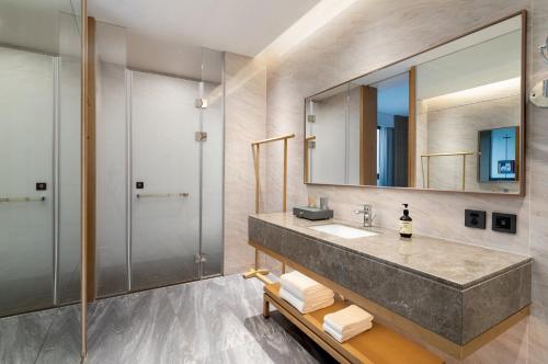 a bathroom with a sink and a mirror at Holiday Inn Ningbo Xiangshan Damu Bay by IHG in Xiangshan