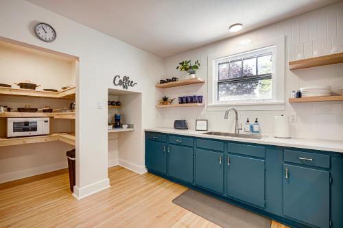 a kitchen with blue cabinets and a window at Helena Apartment with Patio Less Than 1 Mi to Downtown! in Helena