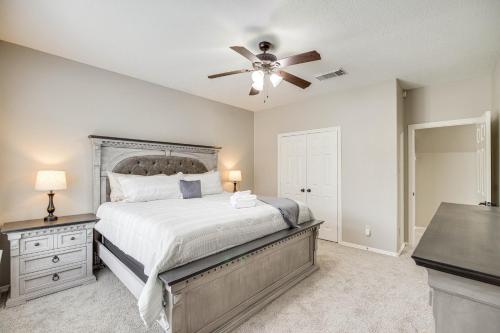a bedroom with a bed and a ceiling fan at Expansive Home in Humble Near Lake Houston! in Humble