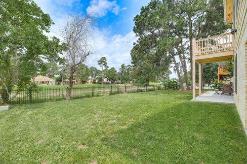 an open yard with a fence and a deck at Expansive Home in Humble Near Lake Houston! in Humble