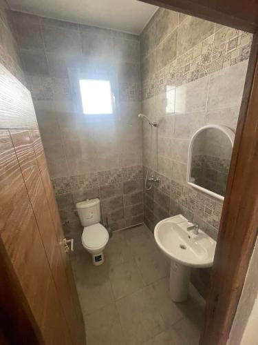 a bathroom with a toilet and a sink at Residence bellevue in Menzel Jemil