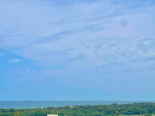 a clear blue sky with a house in the distance at Residence bellevue in Menzel Jemil