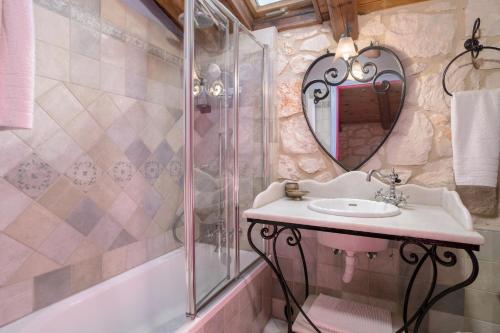a bathroom with a sink and a mirror at Aresti Mountain Resort in Agios Leon