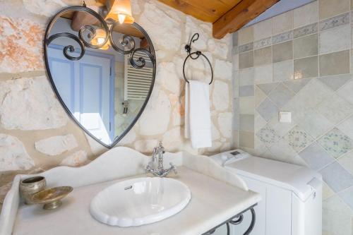 a bathroom with a sink and a mirror at Aresti Mountain Resort in Agios Leon