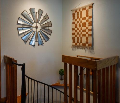 a clock on the wall next to a staircase at Alpenglow Three Bedroom Two Bath XL – A16 in Ouray