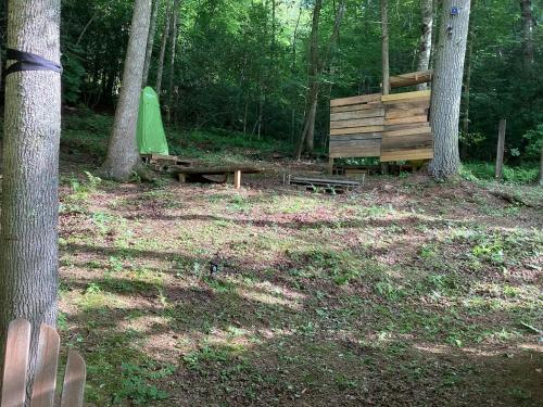 a park with a bench and a tent in the woods at GLAMPING Off Grid Tent ULTIMATE IN COMFORT in Turtletown