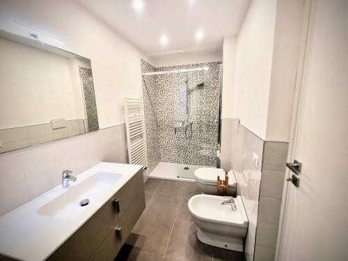 a bathroom with a sink and a toilet and a shower at Sanremo Suite Apartment in Sanremo