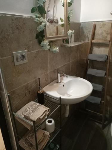 a bathroom with a white sink and a staircase at Jeppson home in Terni