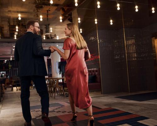 a man and a woman dancing in a red dress at Radisson Blu Seaside Hotel, Helsinki in Helsinki