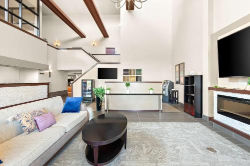 a living room with a couch and a table at Best Western West Towne Suites in Madison