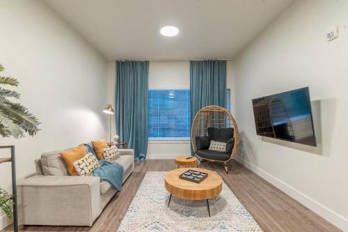 a living room with a couch and a chair at Blue Breakaway with Free Parking and Sleeps 9, Book 7 days, Get 20 Percent OFF in East Orange