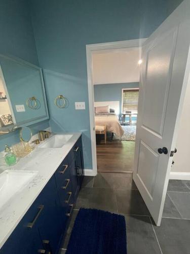 a bathroom with a sink and a room with a bed at Serenity away from the big city in Amelia