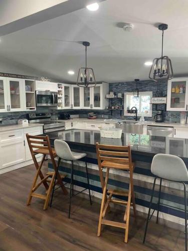 a kitchen with two chairs and a counter top at Serenity away from the big city in Amelia