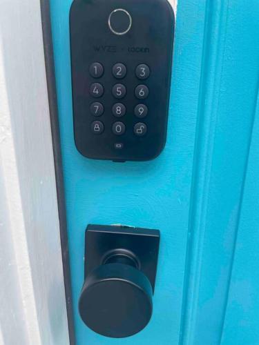 a remote control and a mouse on a blue door at Serenity away from the big city in Amelia