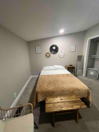 a bedroom with a bed and a clock on the wall at Serenity away from the big city in Amelia