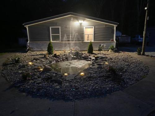 a house with a garden in front of it at night at Serenity away from the big city in Amelia