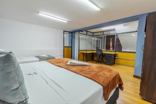 Una cama o camas en una habitación de Poblado Guest House