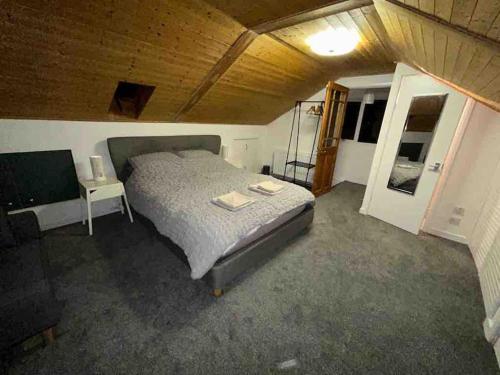 a bedroom with a bed and a table and a chair at Brambles, Ebford, Devon in Exeter