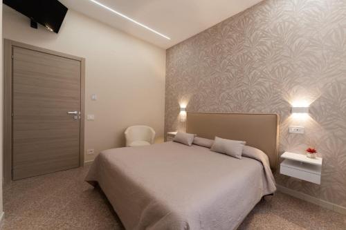 a bedroom with a bed and a wall at Leonardo's B&B in Agerola