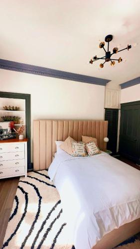 a bedroom with a large bed and a ceiling fan at River Haven Edinburgh in Edinburgh