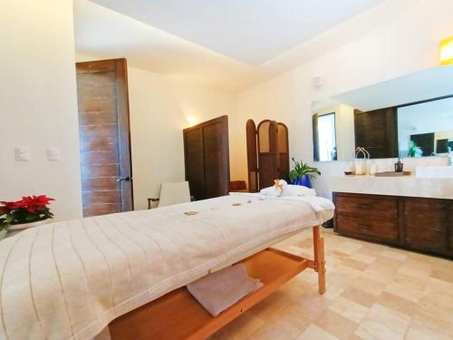 a large bedroom with a large bed and a sink at casa Nirvana in San Miguel de Allende
