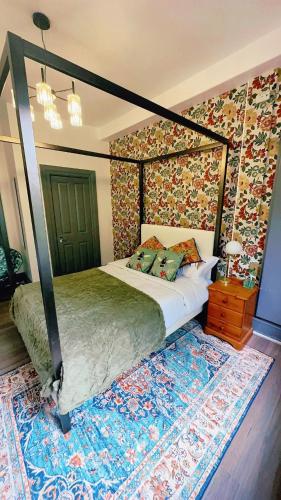 a bedroom with a four poster bed and a rug at River Haven Edinburgh in Edinburgh