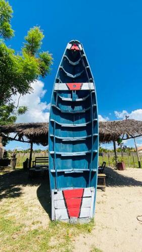 a canoe sitting on the sand on the beach at CasaMares Macapá - Praia de Macapá in Macapá