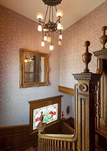 a living room with a mirror and a staircase at The Gibson Mansion Bed and Breakfast in Missoula