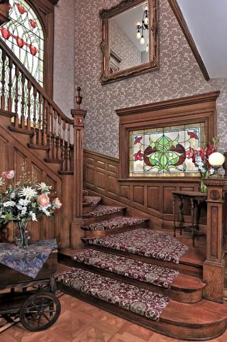 a room with a staircase and a stained glass window at The Gibson Mansion Bed and Breakfast in Missoula
